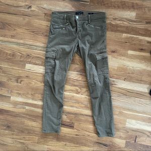 Olive green skinny jeans with side and zipper pockets